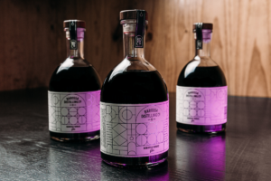 2022 Barossa Shiraz Gin bottles with purple light shining on them